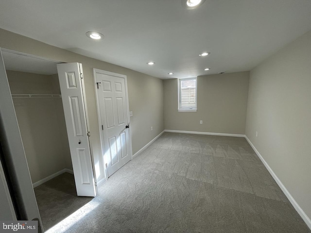 basement featuring carpet, baseboards, and recessed lighting