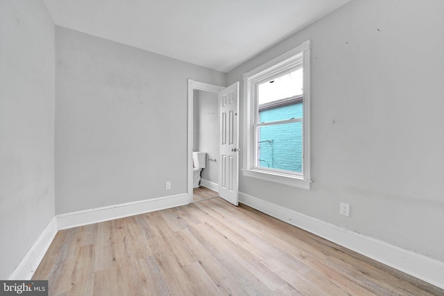 unfurnished bedroom featuring light wood finished floors and baseboards