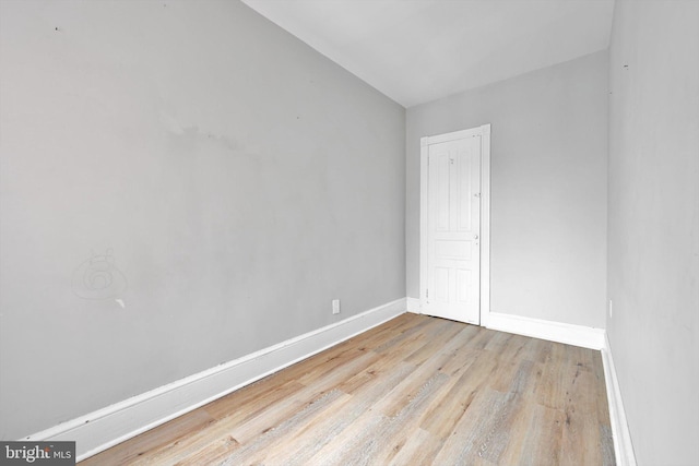 empty room with light wood-style floors and baseboards