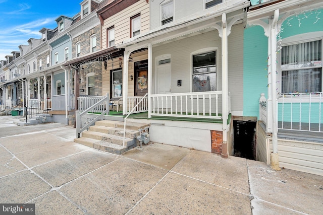 doorway to property featuring mansard roof