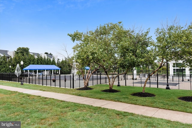 surrounding community featuring fence, a lawn, and a gazebo