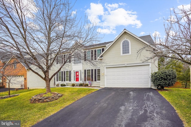 view of front of house featuring a front yard, driveway, and an attached garage