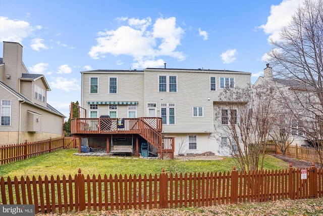 back of property featuring stairway, a fenced backyard, a yard, and a deck