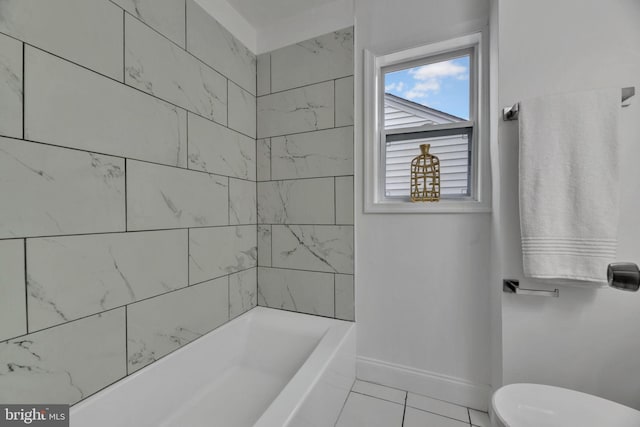 full bath featuring a tub, tile patterned flooring, toilet, and baseboards