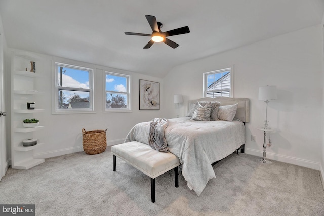 bedroom featuring lofted ceiling, light carpet, and baseboards