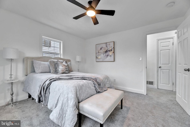 bedroom featuring light carpet, visible vents, baseboards, and ceiling fan