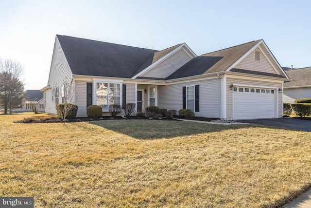 view of front of property featuring a front yard, roof with shingles, driveway, and an attached garage