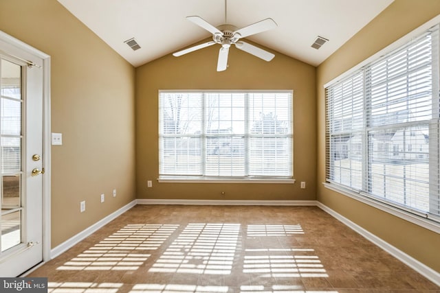 spare room featuring lofted ceiling, plenty of natural light, and visible vents