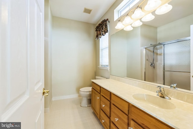 bathroom with visible vents, toilet, an enclosed shower, vanity, and baseboards