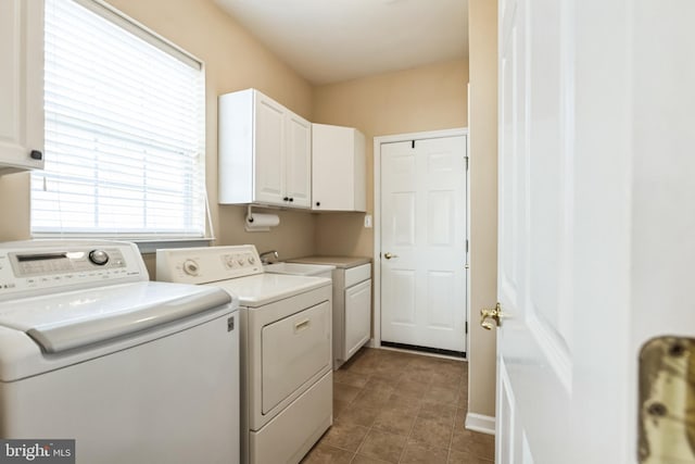 laundry area with cabinet space and separate washer and dryer