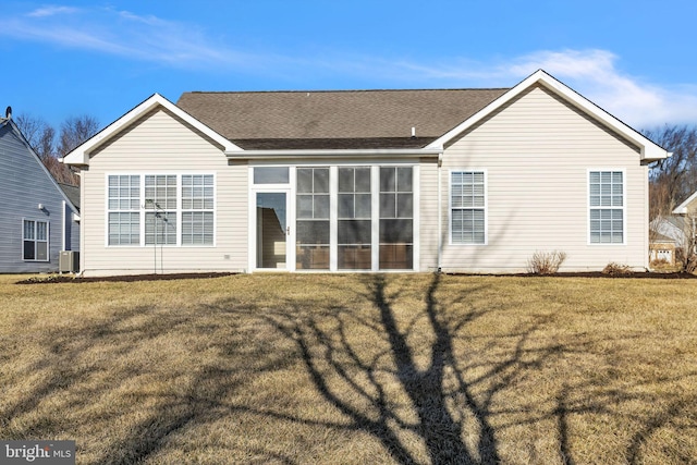 back of property with a lawn and central AC unit