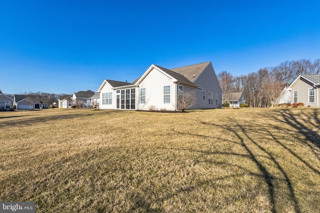 view of property exterior featuring a lawn and a residential view