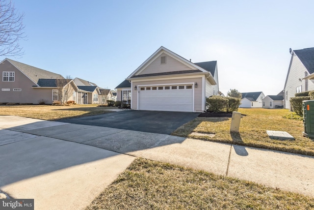 view of front of home featuring driveway, a front lawn, and a residential view