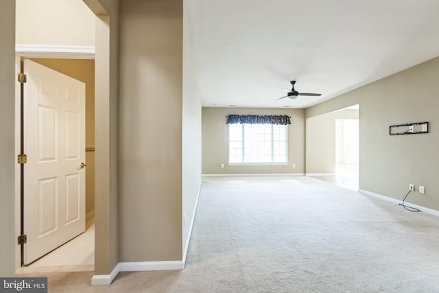 interior space featuring light carpet and baseboards