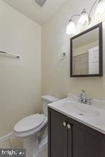 half bath with vanity and toilet