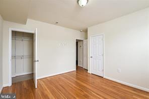unfurnished bedroom featuring baseboards and wood finished floors
