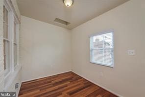 spare room featuring wood finished floors