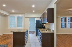 kitchen with recessed lighting, light wood finished floors, dark brown cabinets, and light countertops