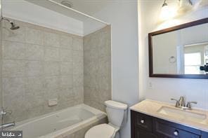 bathroom with vanity, toilet, and shower / bathtub combination