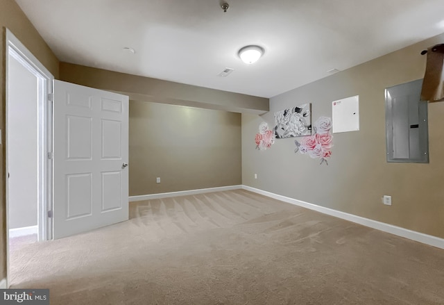 basement with visible vents, electric panel, baseboards, and light colored carpet