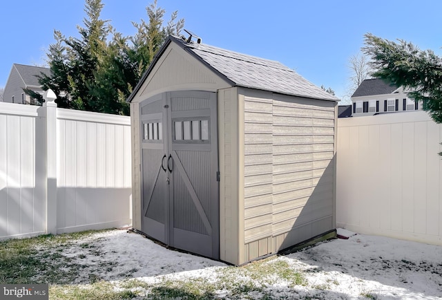 view of shed with fence