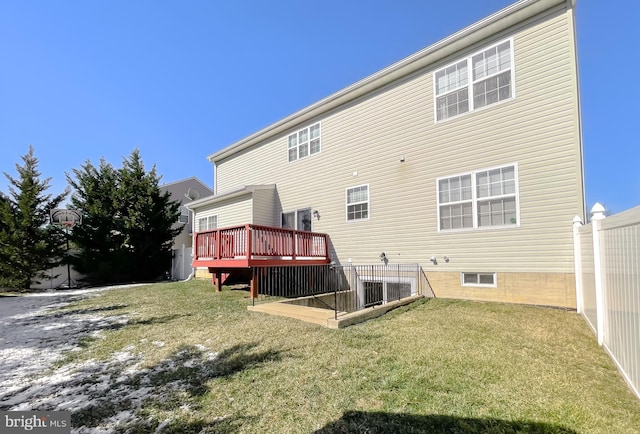 back of house featuring a yard and a wooden deck