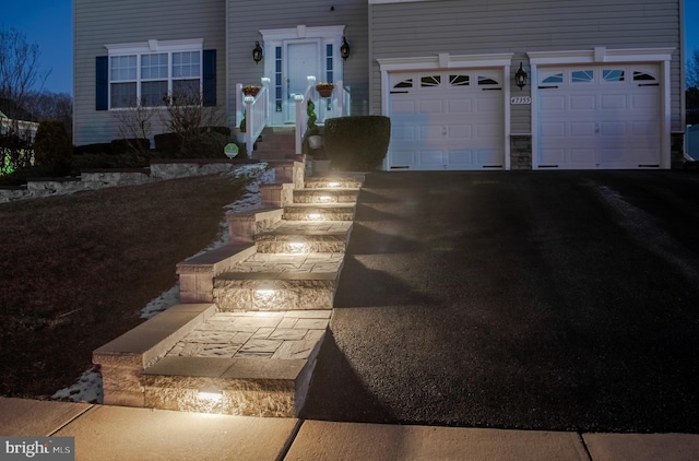 exterior space with aphalt driveway and an attached garage