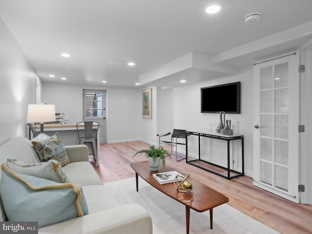 living room featuring recessed lighting, baseboards, and wood finished floors