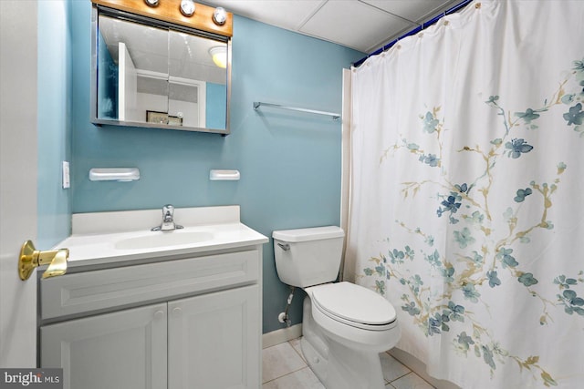 bathroom with tile patterned flooring, toilet, vanity, baseboards, and a shower with curtain