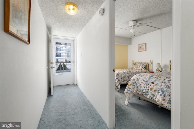 bedroom with carpet, ceiling fan, and a textured ceiling