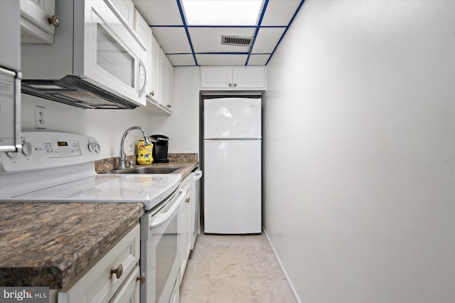 kitchen with a paneled ceiling, visible vents, white cabinetry, a sink, and white appliances