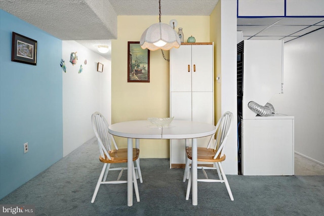 dining room with carpet and a textured ceiling