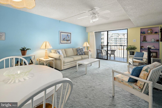 living area with a textured ceiling, a ceiling fan, and carpet flooring