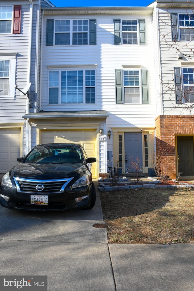 townhome / multi-family property featuring a garage and concrete driveway