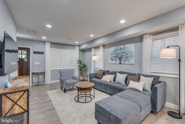 living area with light wood finished floors, baseboards, and recessed lighting