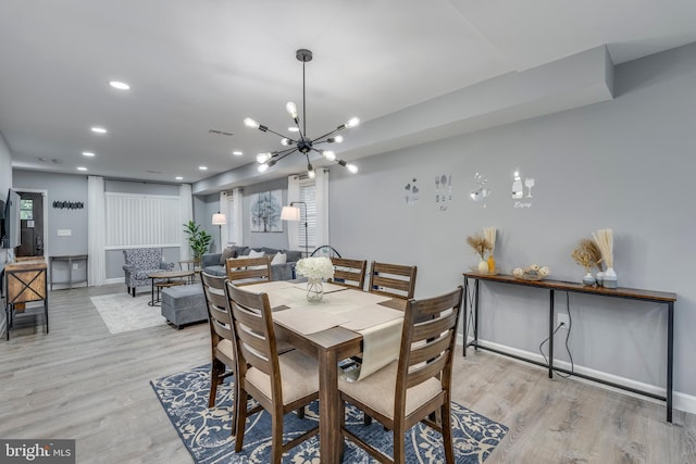 dining room featuring baseboards, light wood-style flooring, and recessed lighting