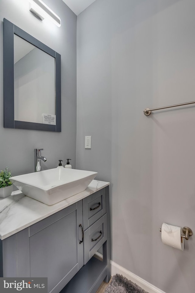 bathroom with vanity and baseboards