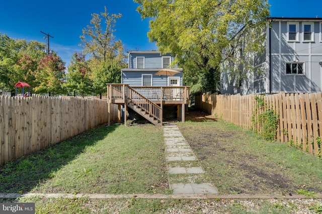 back of house with a yard, a fenced backyard, stairs, and a wooden deck