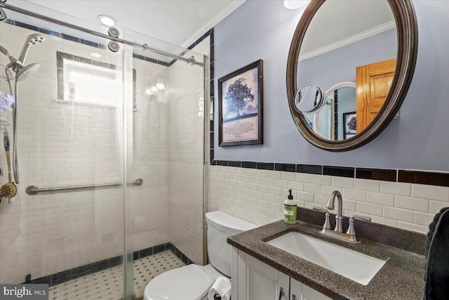 full bath with toilet, vanity, tile walls, a shower stall, and crown molding