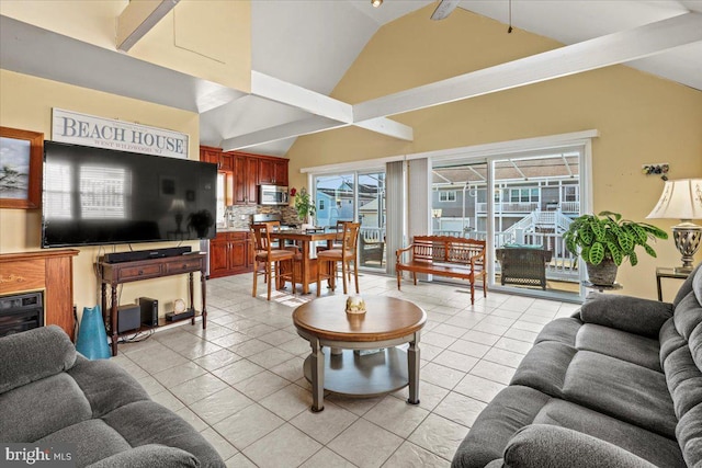 living room featuring high vaulted ceiling and light tile patterned flooring