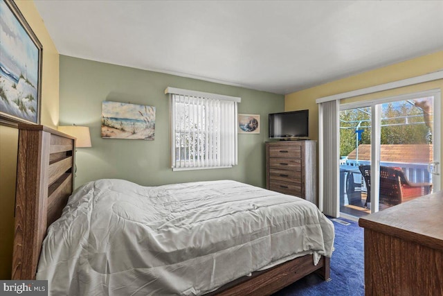 carpeted bedroom featuring access to exterior