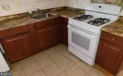 kitchen featuring light tile patterned floors, gas range gas stove, and a sink