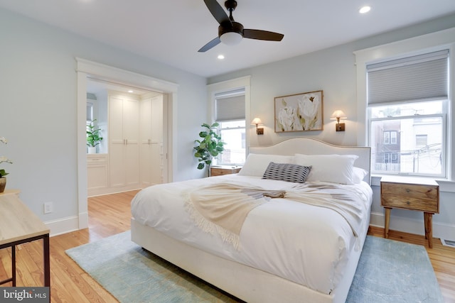 bedroom with ceiling fan, recessed lighting, visible vents, baseboards, and light wood-style floors