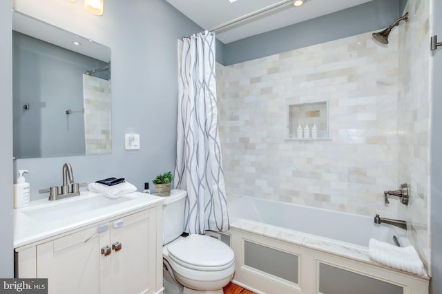 bathroom with toilet, shower / bathtub combination with curtain, and vanity