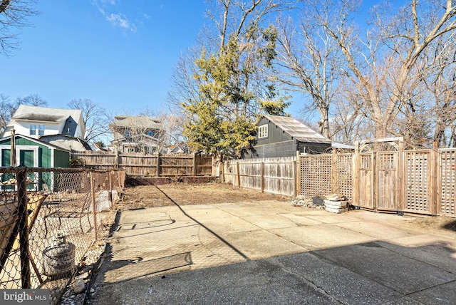 view of yard with an outbuilding, a storage shed, and a fenced backyard