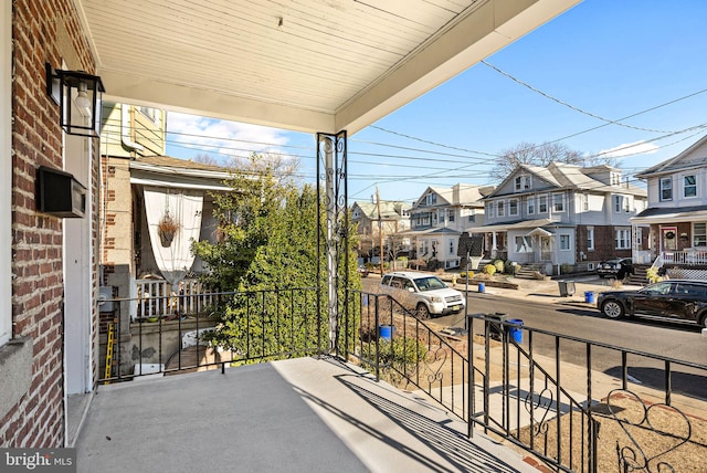 balcony featuring a porch and a residential view