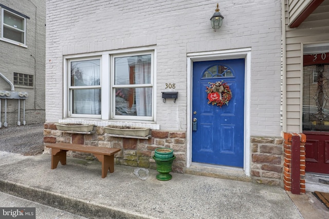 entrance to property with brick siding