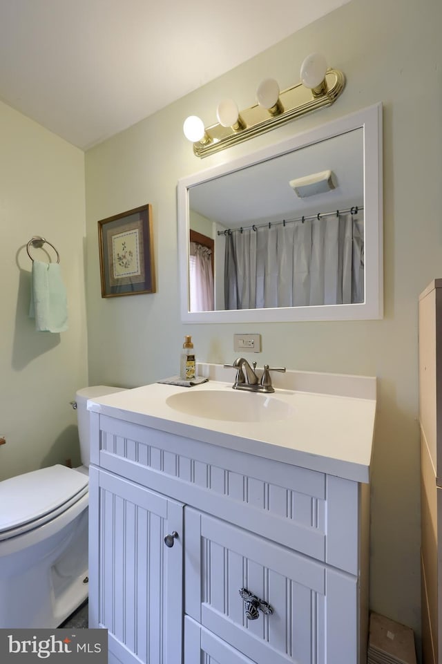 full bathroom featuring vanity and toilet