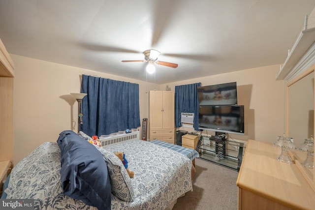 bedroom with ceiling fan, radiator, and carpet