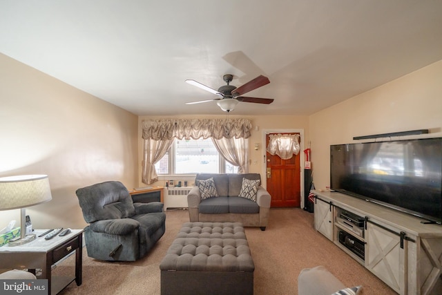 living room featuring light colored carpet, radiator heating unit, and ceiling fan